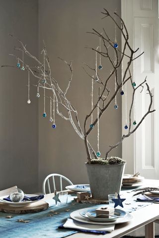 Simple Christmas centerpiece of baubles on branches