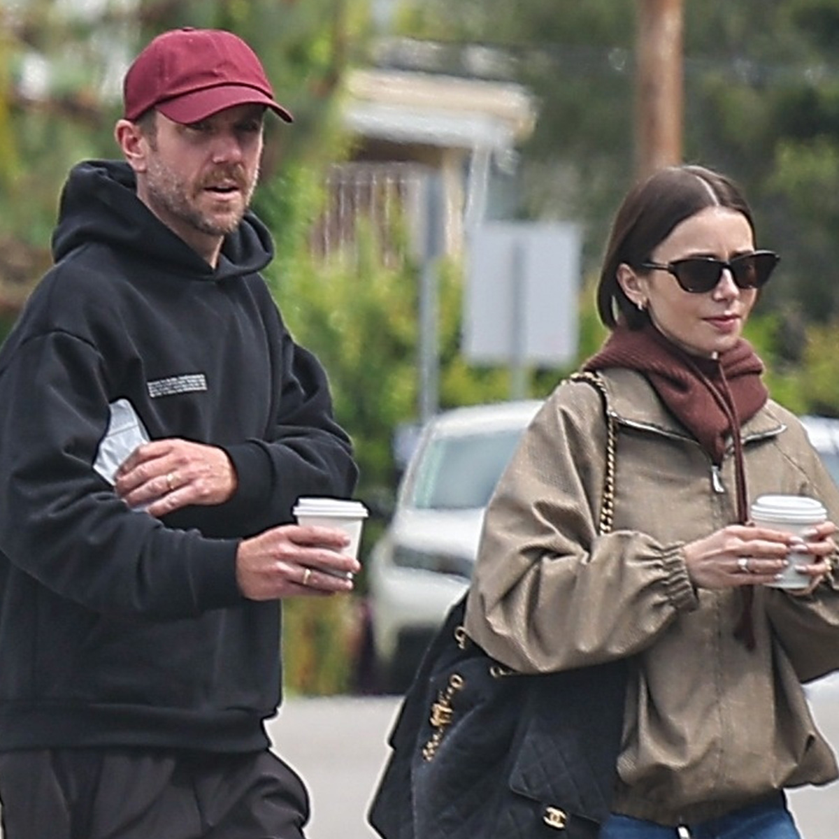 Lily wears a khaki jacket and chanel bag with her husband Charlie McDowell.