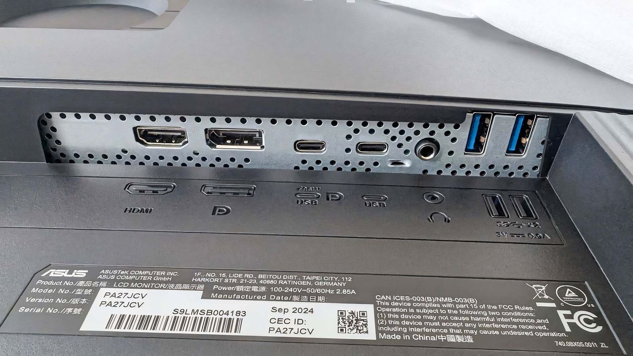 A close-up of the ASUS ProArt PA27JCV 's back ports showing an HDMI, DisplayPort, two USB-C, and two USB-A.