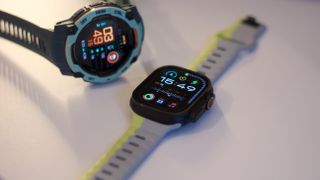 Garmin Instinct 3 next to the Apple Watch Ultra 2