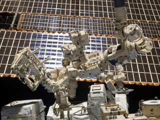 Dextre, the Canadian Space Agency's two-armed telemanipulator, sits outside the International Space Station, ready to perform delicate operations with its array of power tools. Dextre passed its