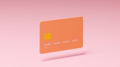 Conceptual image of an orange credit card with letters spelling "debt" instead of account numbers hovering above a pink background