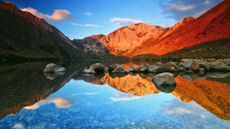 Sunrise at Convict Lake with clouds reflected in the blue water