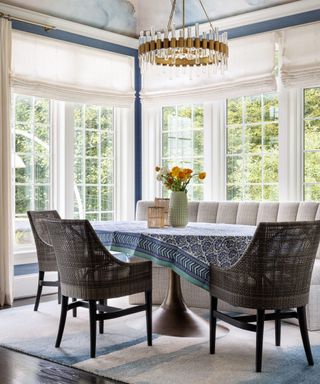 Dining nook with wrap around windows and gray bench seating