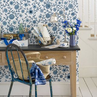 room with floral wallpaper and table and chair