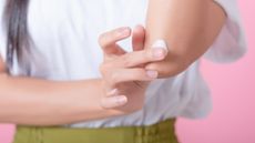 Someone applying a soothing cream to their eczema