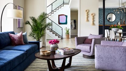 Colors that go with lavender: Living room with lavender armchairs and dark blue sofa