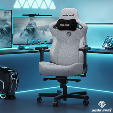 A grey AndaSeat gaming chair next to a desktop.