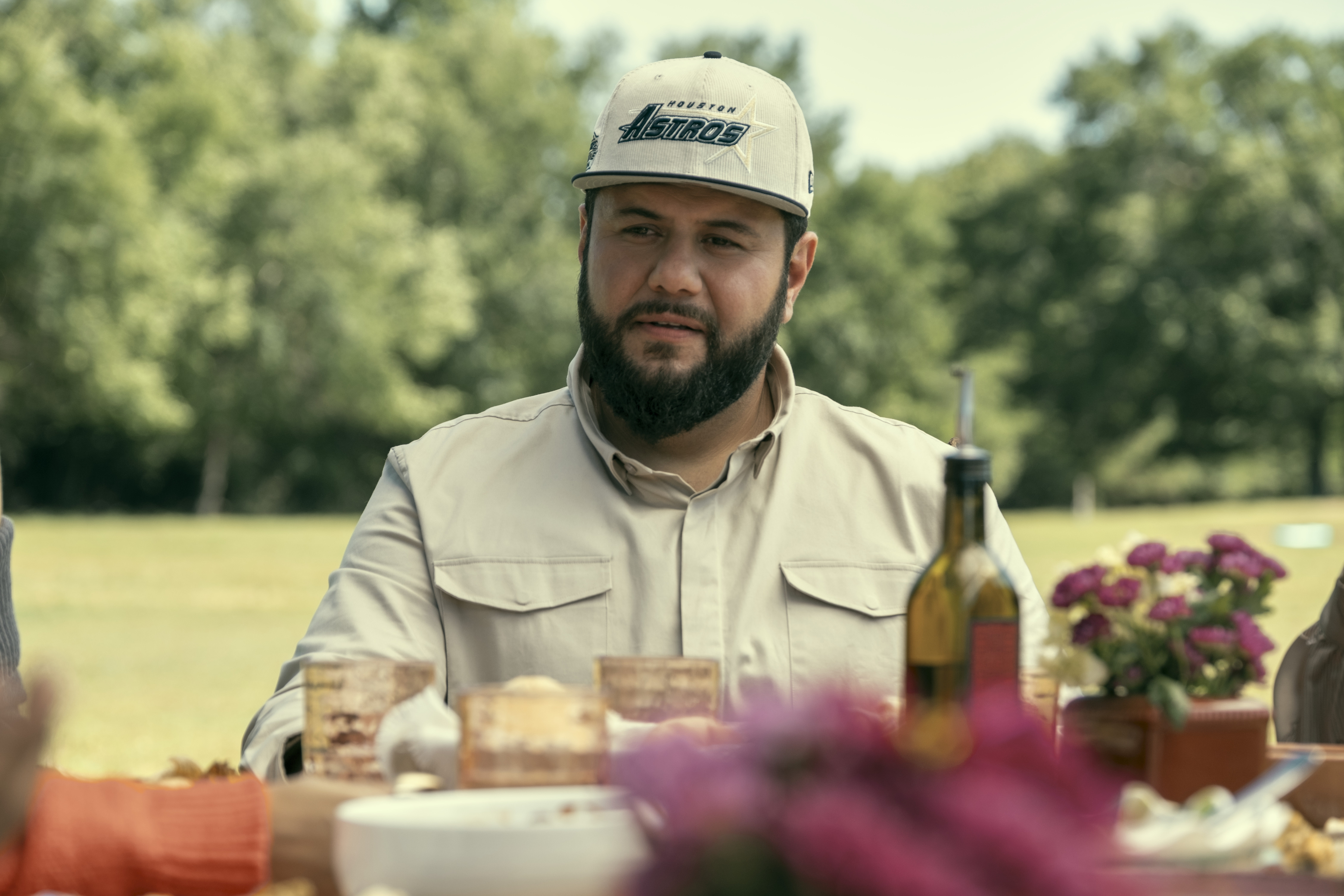 Mo Amer as Mo, sitting at a dinner table, in episode 207 of MO.