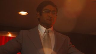 Kumail Nanjiani as Steve Banerjee looking of the club in Welcome to Chippendales