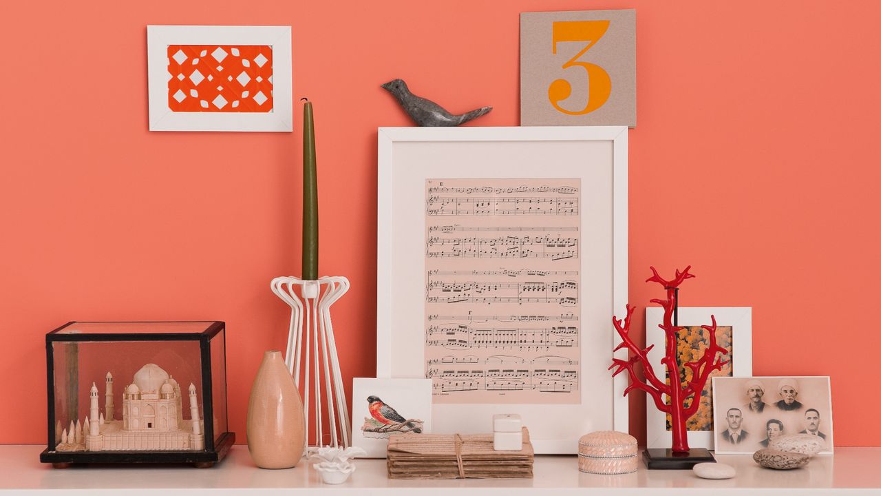 Orange painted wall with decorative items hanging against it