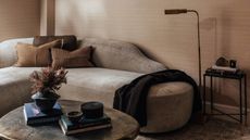 A sculptural sofa in a contemporary living room.