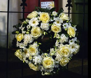 WARNING: Embargoed for publication until 00:00:01 on 08/03/2016 - Programme Name: Eastenders - TX: 14/03/2016 - Episode: 5245 (No. n/a) - Picture Shows: A wreath is put on the gate of No 27, Ronnie's house. - (C) BBC - Photographer: Kieron McCarron