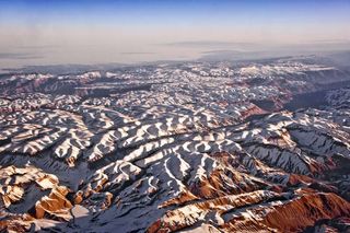 The lofty Himalayas, which stretch some 1,800 miles (2,900 km) along the border between India and Tibet, began to form between 40 million and 50 million years ago, when two large landmasses, India and Eurasia collided. Since the two plates had about the same density, the only way they could relieve the pressure from the crash was to thrust skyward, forming the jagged Himalayan peaks.