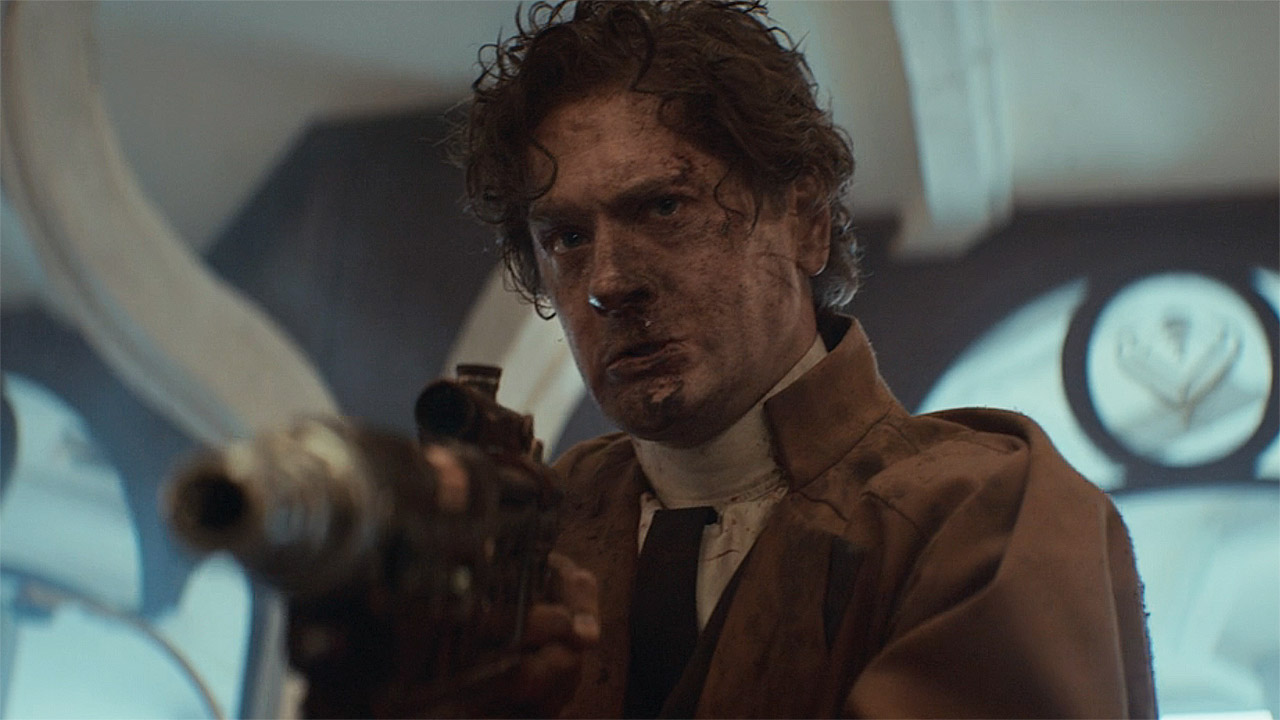 Syril Karn holding an off-camera Cassian at gunpoint in Andor season 2 episode 8