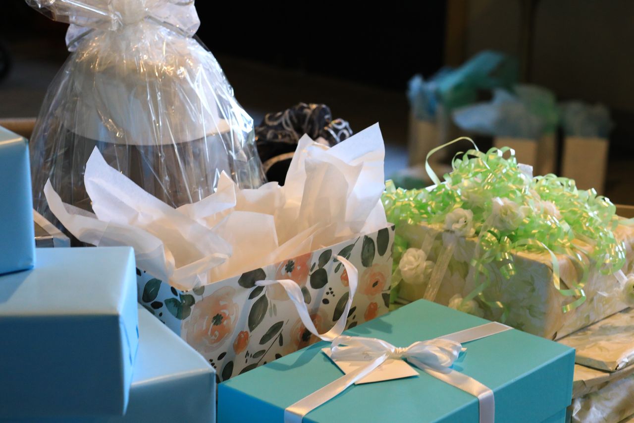 A pile of presents for a wedding, including gift bags and boxes. 