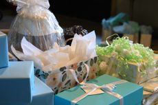 A pile of presents for a wedding, including gift bags and boxes. 