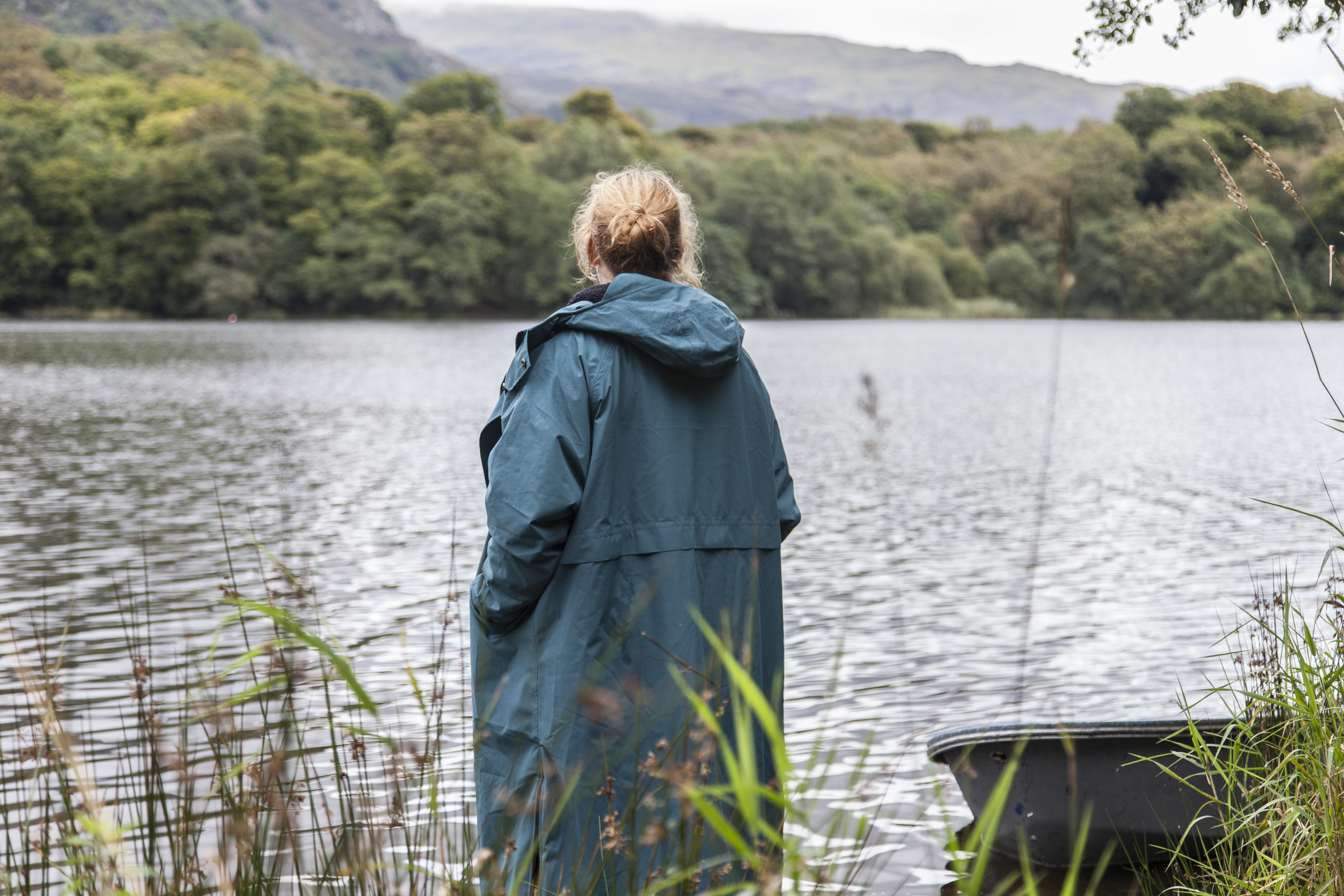 woman wearing Red Alter Evo standing on the banks of Grasmere lake in the Lake District
