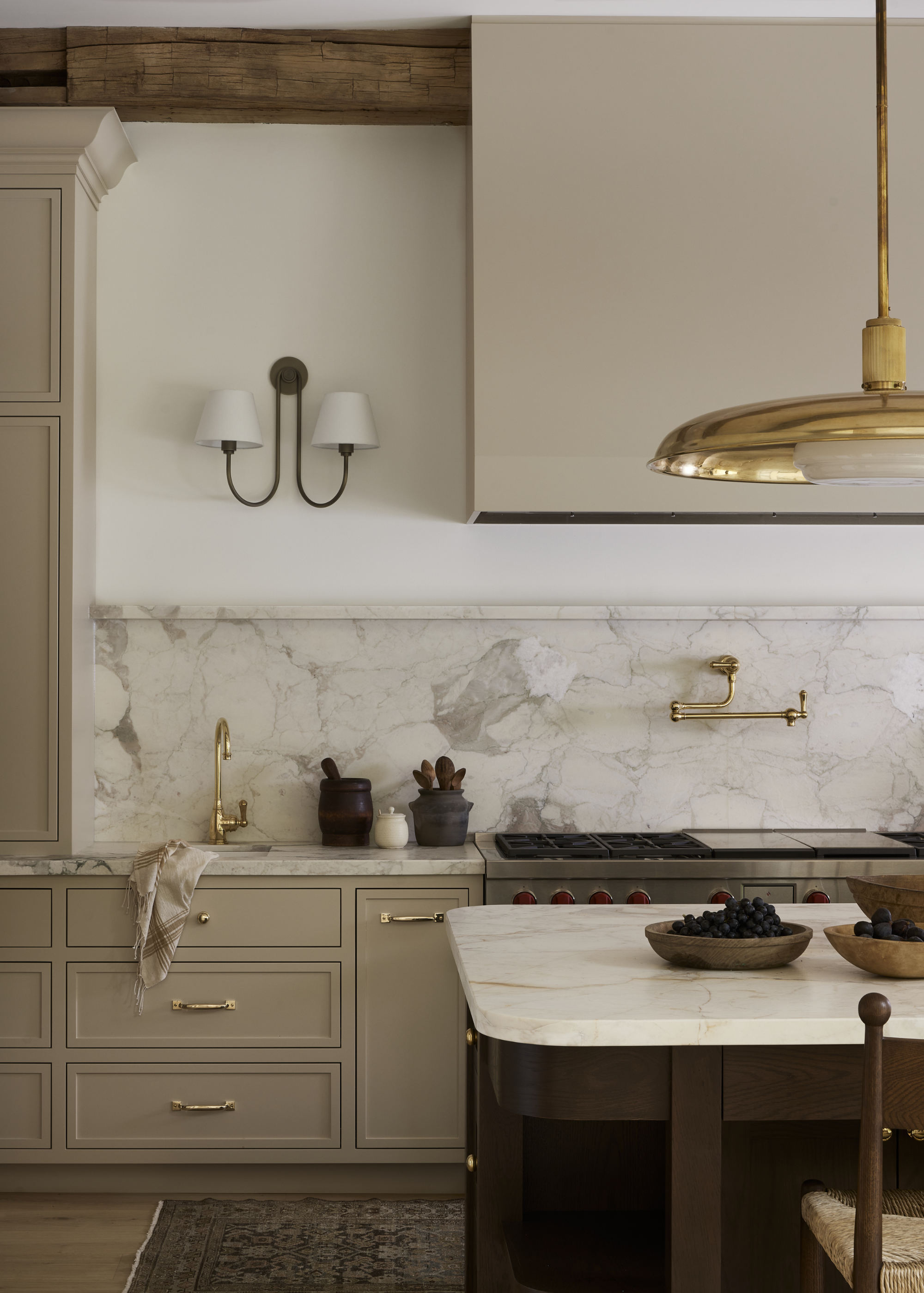 a beige kitchen with a matching cooker hood