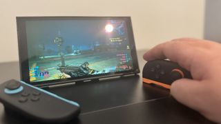 A Nintendo Switch 2, in mouse mode, playing Cyberpunk 2077
