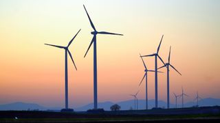 green energy made from wind turbines in the sunset