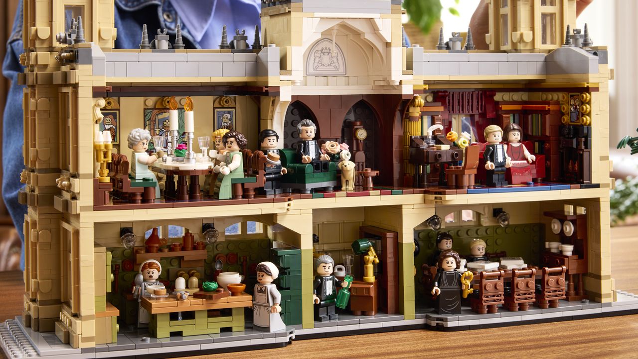 Lego Downtown Abbey interior, with minifigures sat at the dining room table and on other furniture