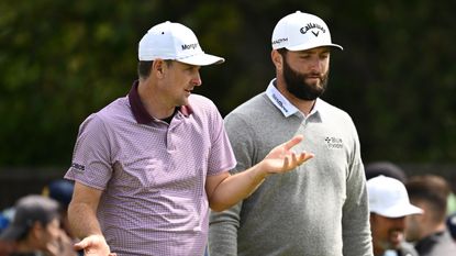 Justin Rose and Jon Rahm talk during a PGA Tour round