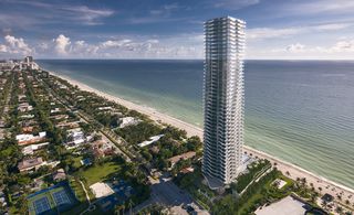View of Regalia Sunny Isles high rise with background view of the beach and ocean