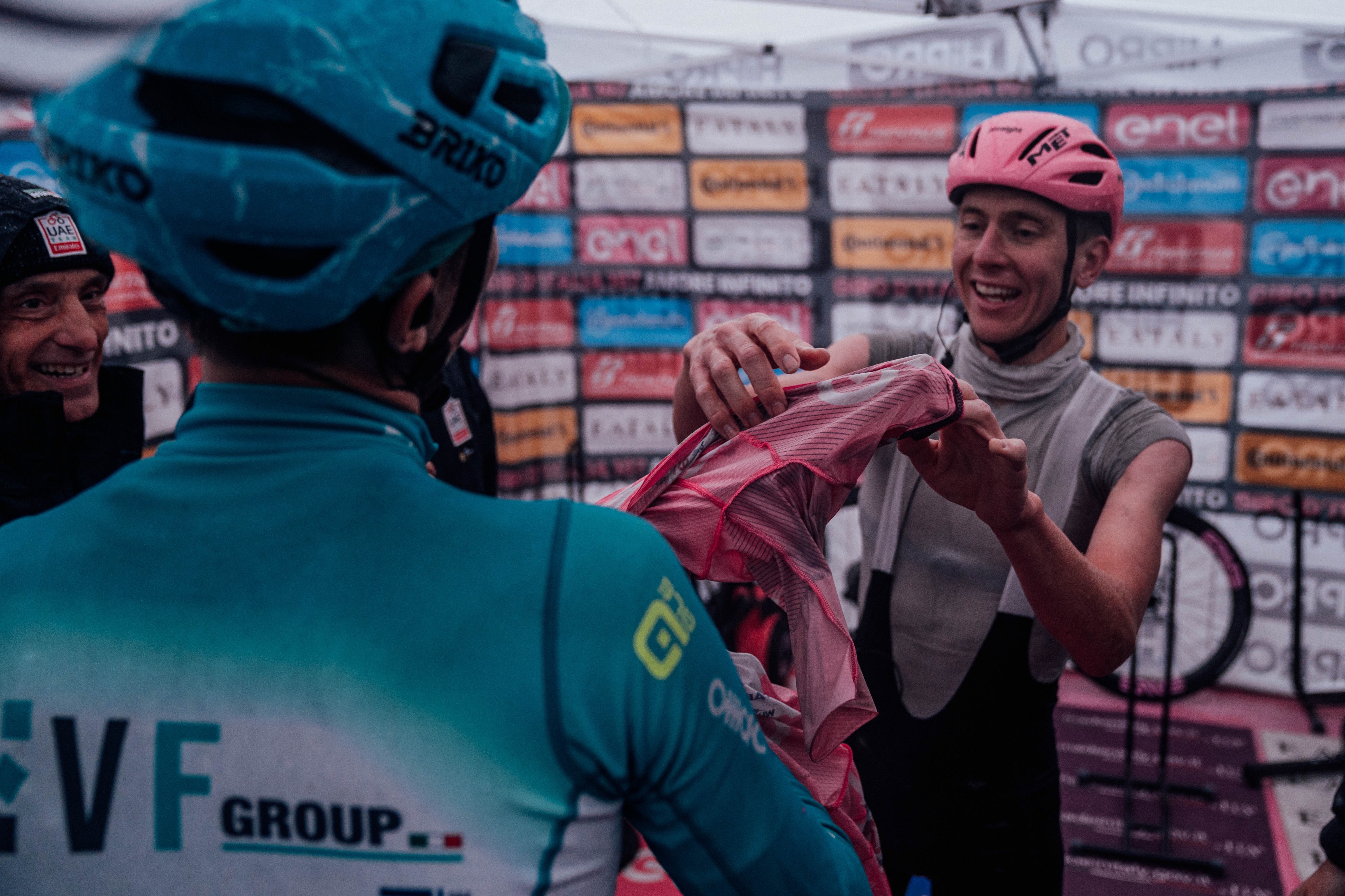 Tadej Pogacar gifts Giulio Pellizzari his pink jersey at the finish of a stage of the 2024 Giro d'Italia