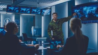 Soldiers discuss a cyberattack