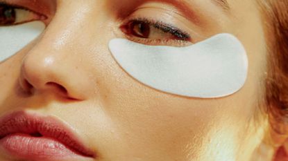 How to get rid of dark circles: Young Woman Wearing An Undereye Mask