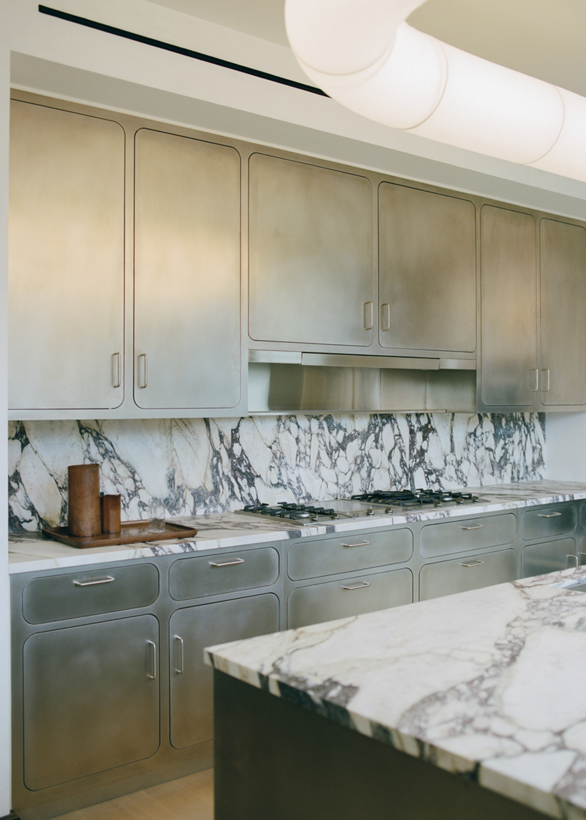 stainless steel kitchen with marble backsplash
