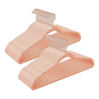 A cutout of a bunch of pink velvet hangers on a white background