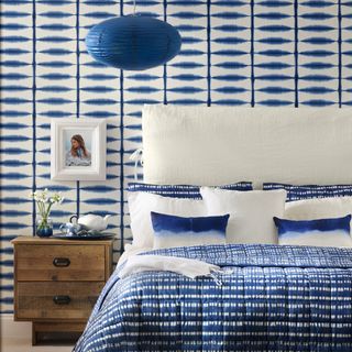 bedroom with blue and white wall and double bed