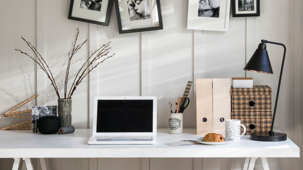 Fix your appliances a white laptop in a white room on a desk with box files