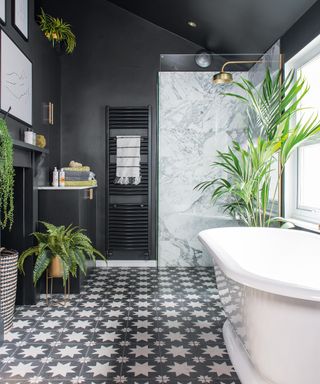 Black bathroom with patterned floor and plants