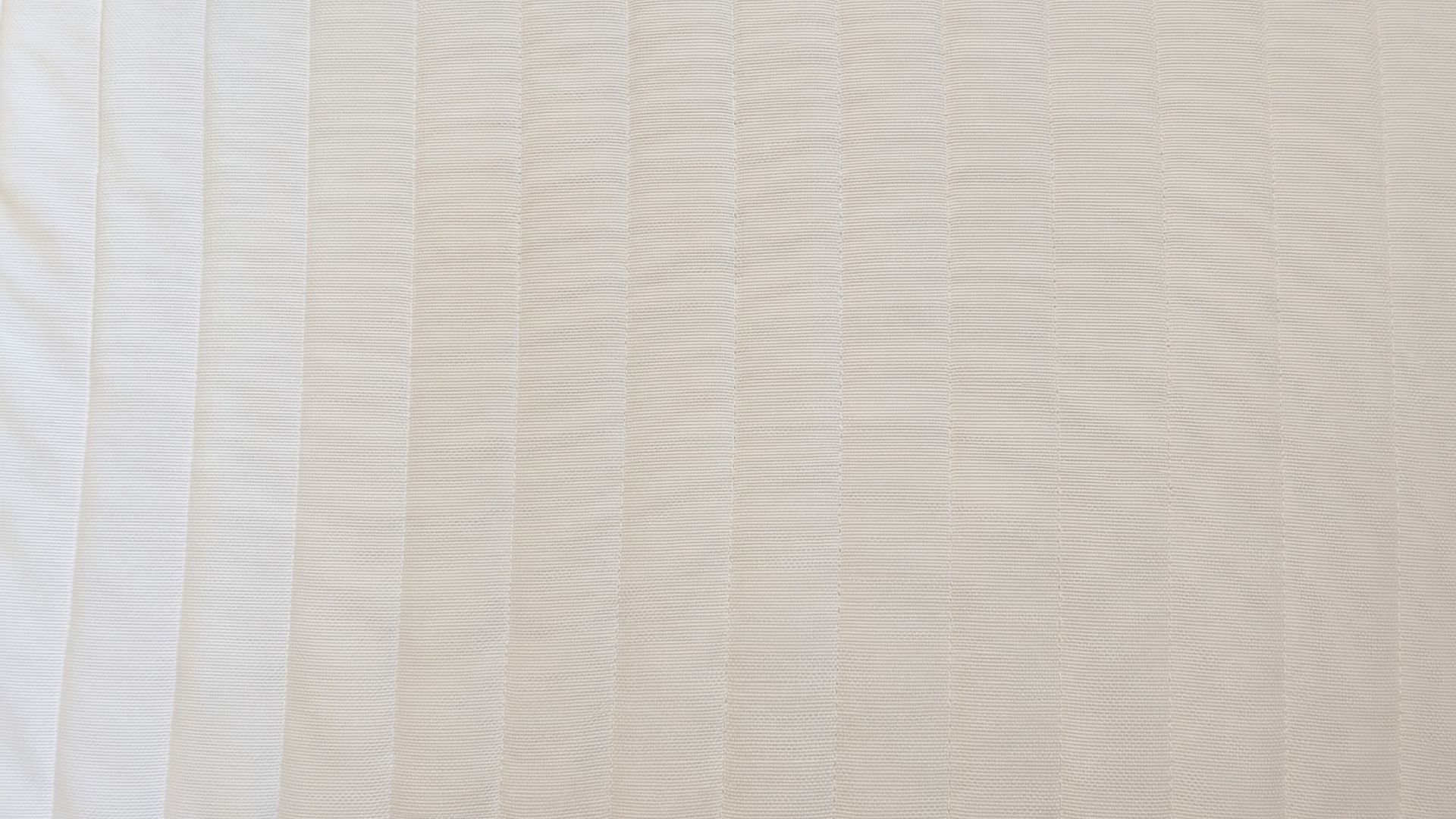 The image shows the bright white surface of the mattress after a thorough deep clean to remove yellow stains