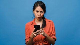 Unimpressed woman using a smartphone