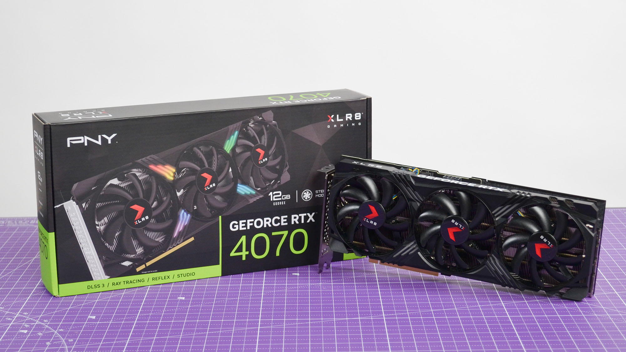 A PNY GeForce RTX 4070 XLR8 OC graphics card on a purple desk mat