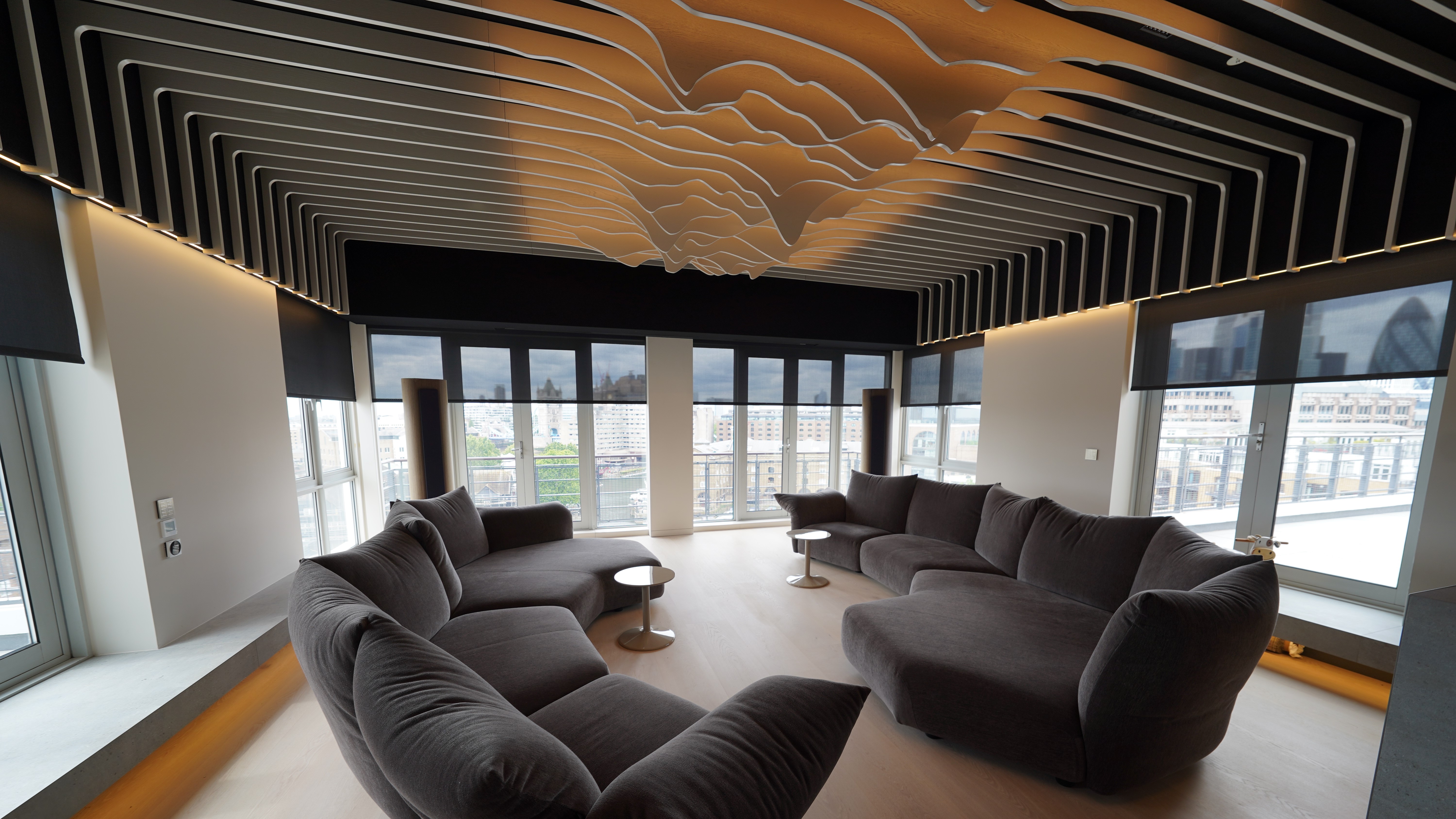 Home theater space with sculptural elements on ceiling