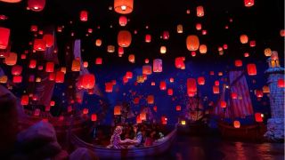 Rapunzel and Flynn in a boat holding hands during Lantern festival in Tokyo DisneySea attraction