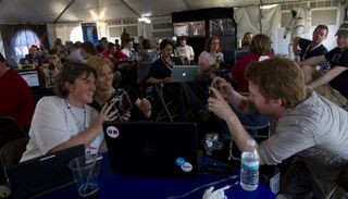 Actor Seth Green, right, takes a quick photo of two NASA Tweeps holding a Golden Orb Spider during the STS-134 Tweetup, Thursday, April 28, 2011, at Kennedy Space Center in Cape Canaveral, Fla., one day before the final launch of shuttle Endeavour.
