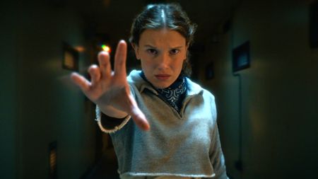 Eleven (Millie Bobby Brown) with her hand outstretched in a scene from Netflix's "Stranger Things" season 5