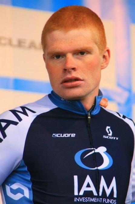 Dominic Klemme steps onto the stage after his IAM Cycling squad took out the team classification
