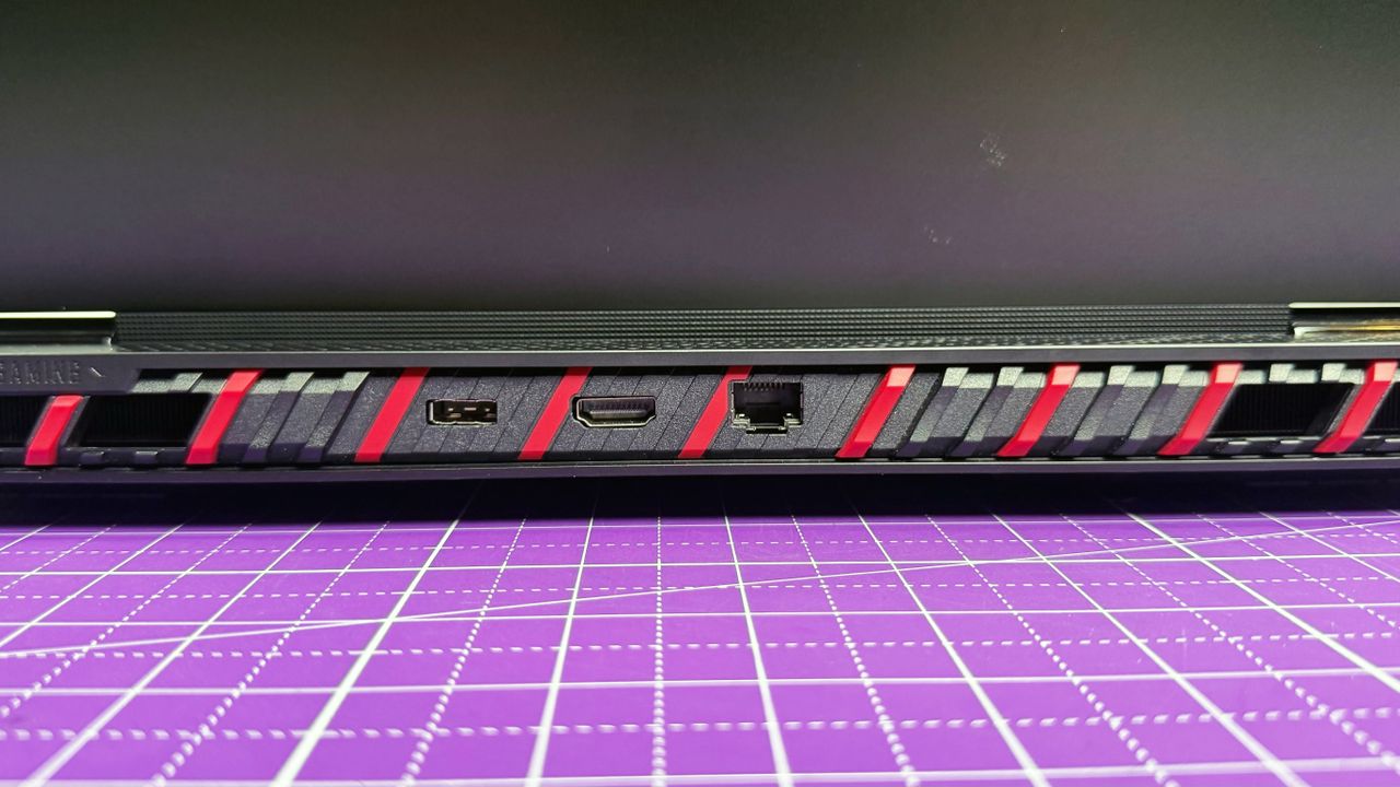 Close up of the rear ports on the MSI Raider 18 HX AI gaming laptop, on a purple mat.