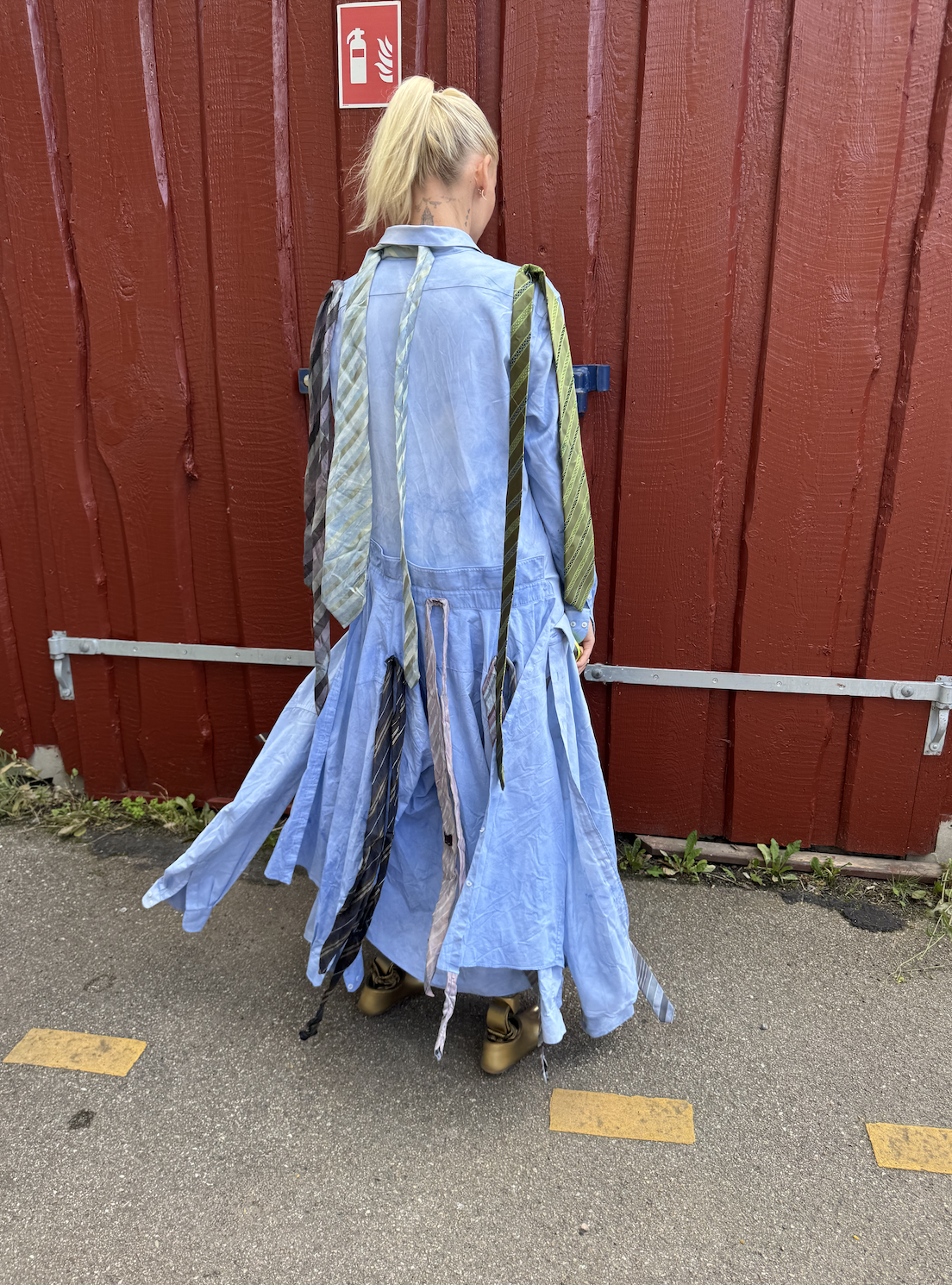 Lauren Wasser wears a two tone blue set with ties draped over her shoulders