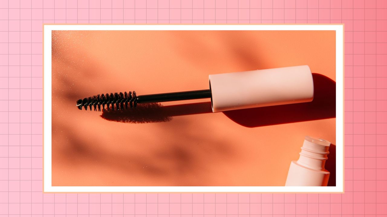 TikTok&#039;s mascara meaning: a close up of a pink mascara tube and wand against an orange background/ in a pink gradient template