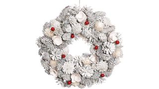 White pinecone wreath with red berries