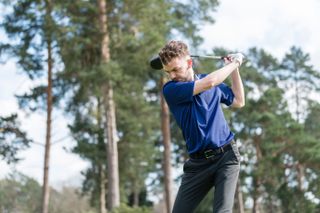 Dan Parker swinging a golf club in the adidas ultimate 365 tour primeknit polo