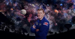 Tim Peake with his arms crossed standing in front of a galaxy background for Secrets of Our Universe with Tim Peake
